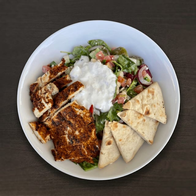 Salted. Greek Salad pictured with blackened chicken.